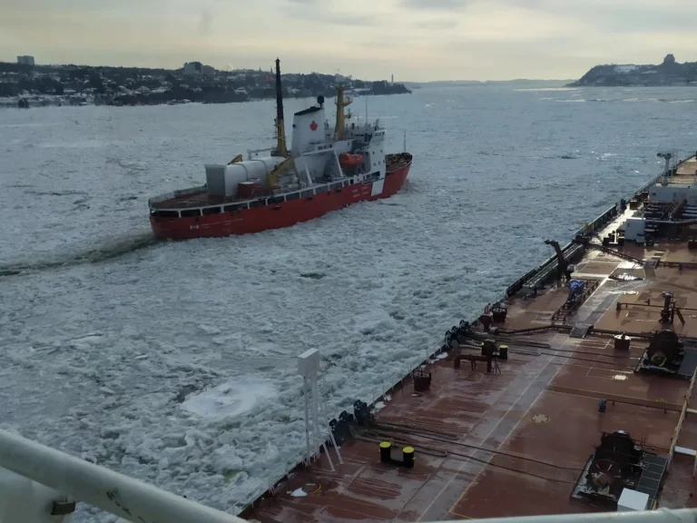 Vessel navigating through icy waters during winter ship operations