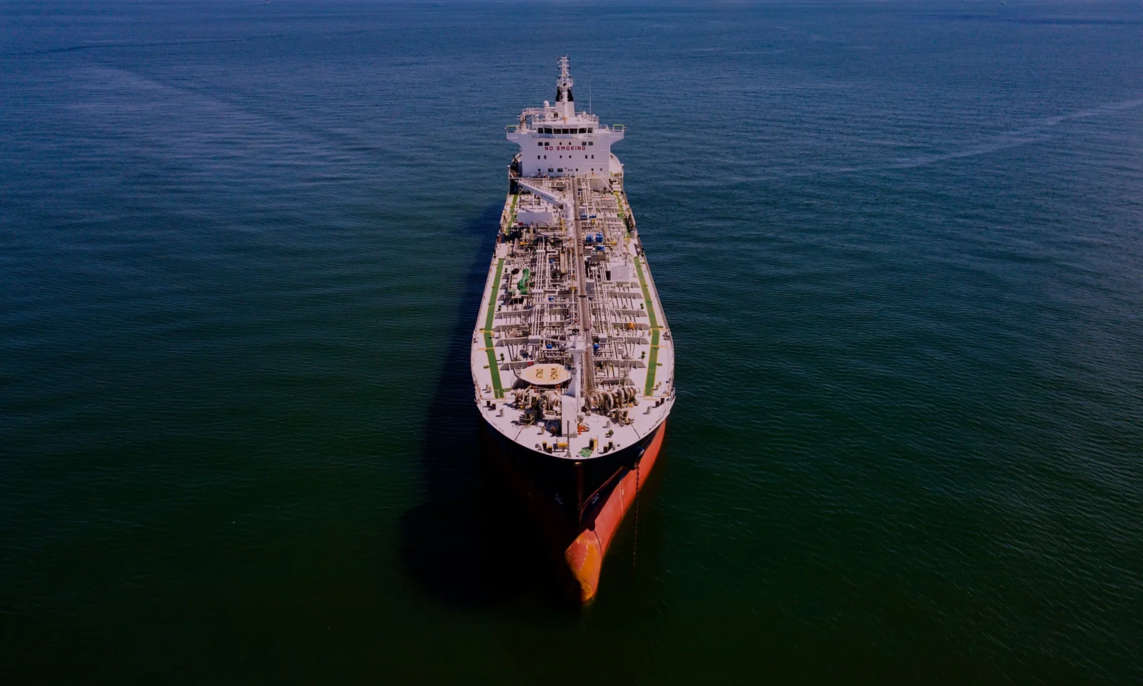 Oil tanker underway at sea at sunset, illustrating off-hire risk under a time charter
